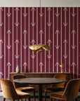 Tranquility Tapestry Oxblood art deco stripe wallpaper behind a walnut credenza and round table in an elegant dining room