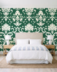 Twilight Garden Veil Emerald damask wallpaper behind a queen bed in a bright coastal bedroom