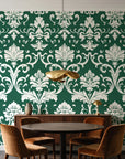 Twilight Garden Veil Emerald damask wallpaper behind a walnut credenza and round table in an elegant dining room