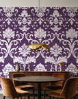 Twilight Garden Veil Plum damask wallpaper behind a walnut credenza and round table in an elegant dining room