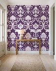 Twilight Garden Veil Plum damask wallpaper behind a console table in a light entry hallway