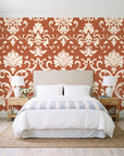 Twilight Garden Veil Terracotta damask wallpaper behind a queen bed in a bright coastal bedroom