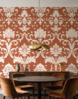 Twilight Garden Veil Terracotta damask wallpaper behind a walnut credenza and round table in an elegant dining room