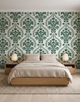 Veiled Botany Sage damask wallpaper behind a low platform bed in a serene Japandi bedroom