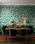 Velvet Vine Serenade Emerald damask wallpaper in a dark moody dining room with a candlelit table