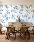 Verdant Scatter Navy tossed leaf wallpaper in a farmhouse dining room with a sage sideboard and rustic trestle table