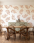 Verdant Scatter Terracotta tossed leaf wallpaper in a farmhouse dining room with a sage sideboard and rustic trestle table