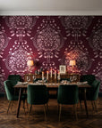 Vintage Eden Oxblood damask wallpaper in a dark moody dining room with a candlelit table