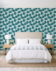 Wild Palm Lagoon palm wallpaper behind a queen bed in a bright coastal bedroom