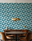 Wild Palm Lagoon palm wallpaper behind a walnut credenza and round table in an elegant dining room