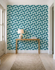 Wild Palm Lagoon palm wallpaper behind a console table in a light entry hallway