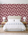 Wild Palm Oxblood palm wallpaper behind a queen bed in a bright coastal bedroom