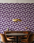 Wild Palm Plum palm wallpaper behind a walnut credenza and round table in an elegant dining room