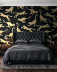 Wild Stride Noir cheetah wallpaper behind a tufted headboard in a dark, moody bedroom