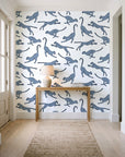 Wild Stride Slate cheetah wallpaper behind a console table in a light entry hallway
