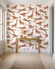 Wild Stride Terracotta cheetah wallpaper behind a console table in a light entry hallway