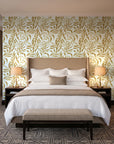 Willow Trace Ochre willow vine wallpaper behind the headboard of a king bed in a contemporary hotel guest room