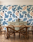 Winter Forage Slate pine bough and berry wallpaper in a farmhouse dining room with a sage sideboard and rustic trestle table