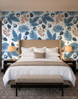 Winter Forage Slate pine bough and berry wallpaper behind the headboard of a king bed in a contemporary hotel guest room