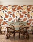 Winter Forage Terracotta pine bough and berry wallpaper in a farmhouse dining room with a sage sideboard and rustic trestle table