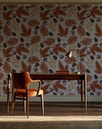 Winter Forage Terracotta pine bough and berry wallpaper as a feature wall in a home study