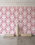 Woodland Blossom Veil Rose damask wallpaper behind a travertine pedestal and vase in a minimal boutique