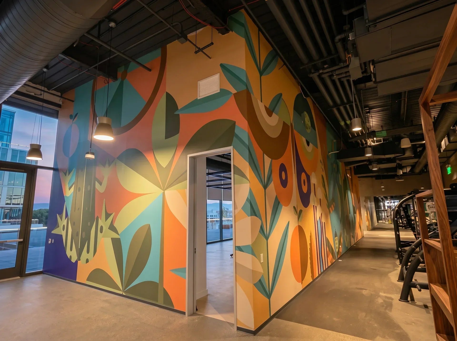 Commercial wallpaper installation — tropical leaf pattern in an office hallway