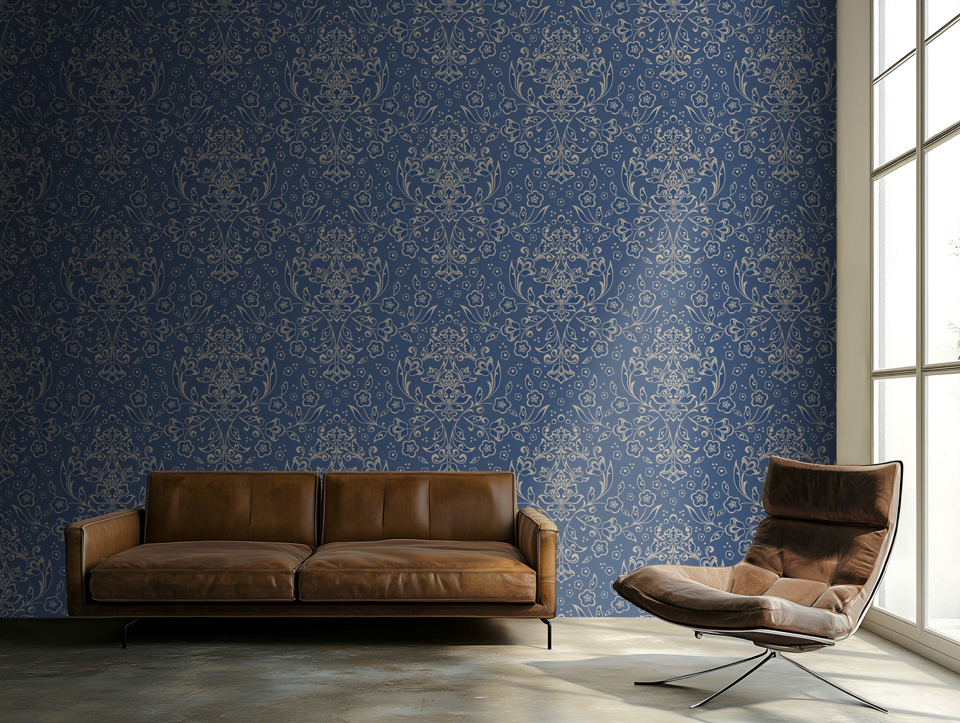 Brown leather sofa and chair against a blue patterned wallpaper