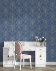 Navy blue and gold Afternoon Arbor damask wallpaper with ornate scrollwork behind white vanity desk
