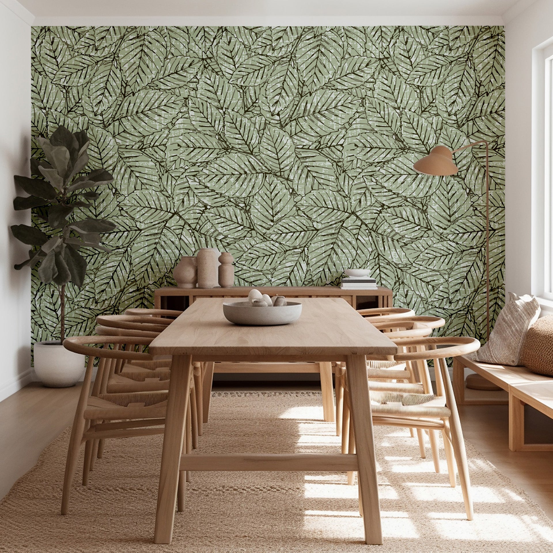 Dining area with wooden table and chairs against a leaf-patterned wall.