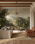 Classical landscape mural wallpaper featuring Alpine Vista with River in earth tones on living room accent wall
