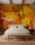 Amber Blaze golden abstract expressionist wallpaper adding character to a cozy bedroom