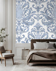 Decorative wallpaper applied to a wall in a bedroom setting.