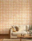 Amber Weave rustic orange plaid wallpaper in a warm and inviting living room