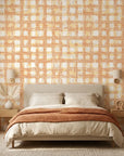 Amber Weave rustic orange plaid wallpaper adding character to a cozy bedroom