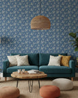 Amber Hour blue botanical leaf wallpaper in a warm and inviting living room