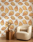 Ancient Ground beige botanical leaf wallpaper in a warm and inviting living room