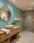 Aqua Rhythm teal and aqua vertical stripe wallpaper creating ambiance in a serene bathroom