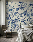 Vintage blue floral wallpaper on a bedroom wall, creating an elegant and timeless interior with classic botanical charm.