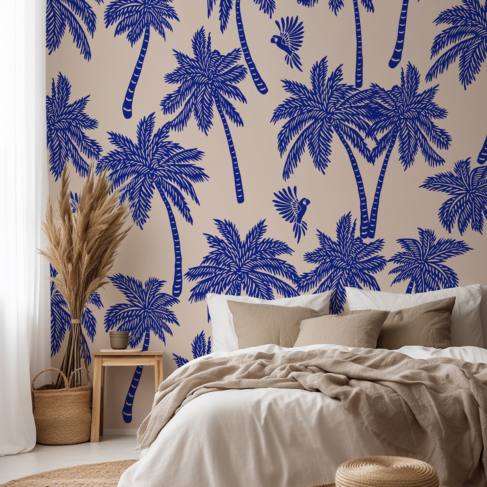 Tropical palm wallpaper featured on a bedroom wall, creating a relaxed coastal interior with bold blue palm silhouettes.