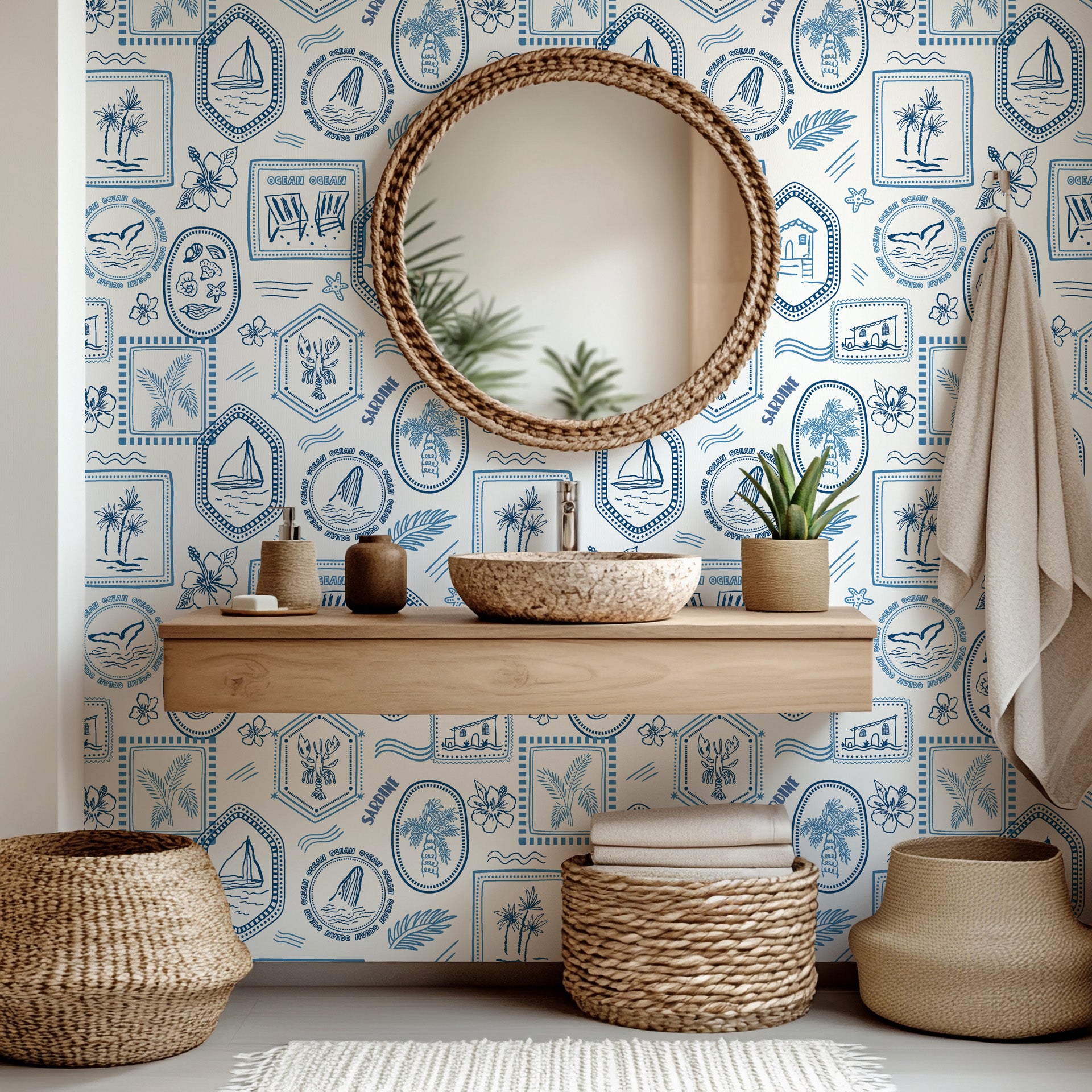 Coastal themed wallpaper used on a bathroom room accent wall, showcasing hand illustrated beach scenes and maritime details in blue and white.