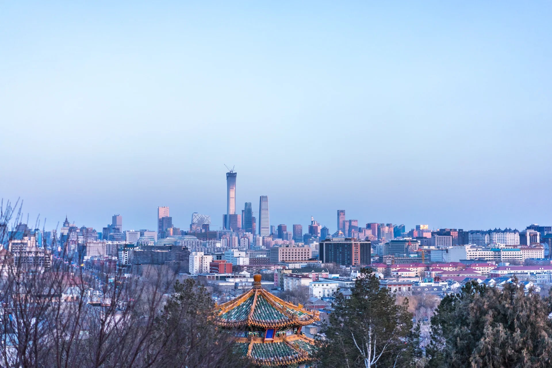 Between Two Worlds wallpaper featuring traditional temple roof against modern city skyline at dusk