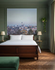 Sage green Between Two Worlds cityscape mural wallpaper behind bed in classic bedroom