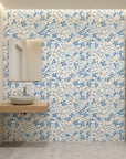Bloom Archive soft blue floral blossom wallpaper creating ambiance in a serene bathroom
