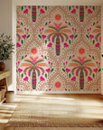 Pink and green palm arch peel and stick wallpaper in a bohemian style featuring tropical leaves