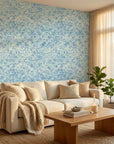 Blue Mirage coastal abstract peel and stick wallpaper in a warm and inviting living room