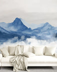 Blue Mountains watercolor mural wallpaper with misty peaks and clouds in modern living room