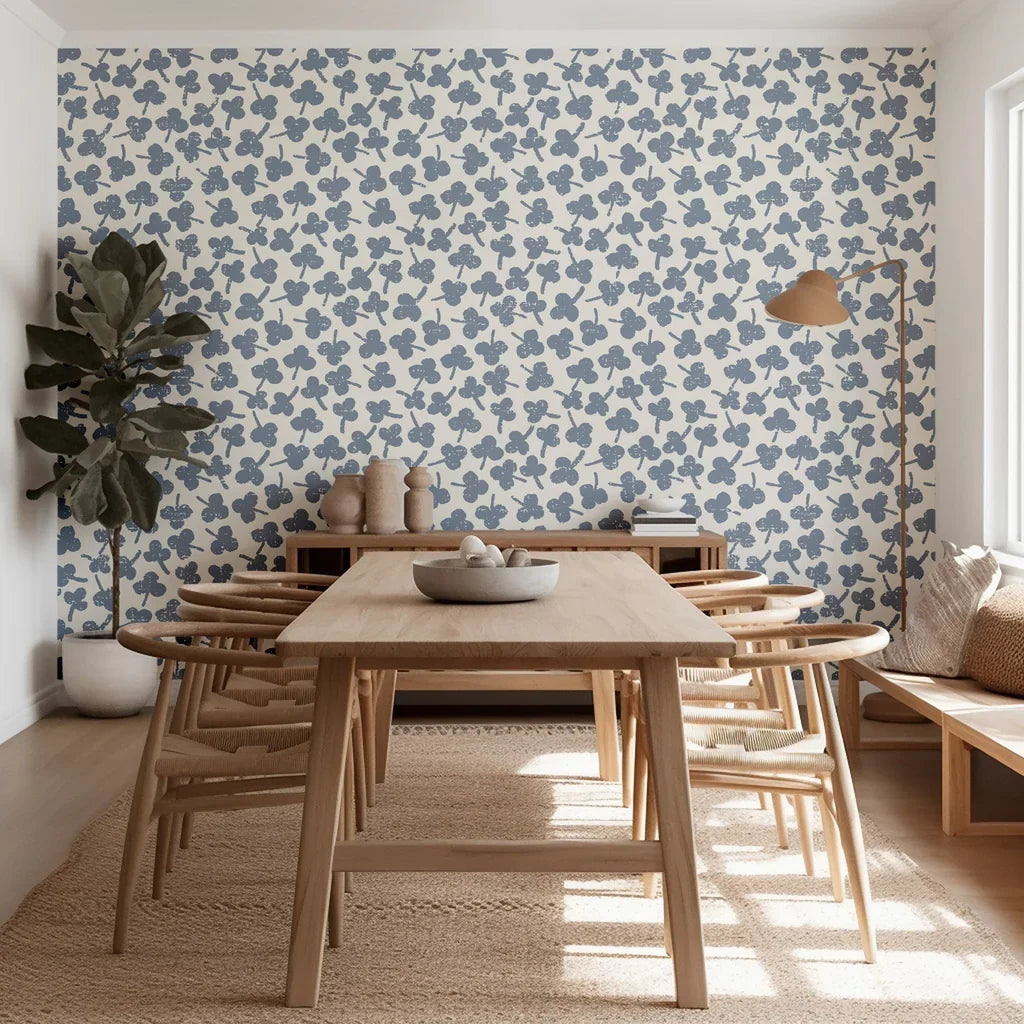 Diminutive, hand-stamped porcelain blue flowers are scattered upon this warm ivory wall covering