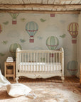 Fanciful hot air balloons and bluebirds soar through the air as the central theme of this vintage baby room design