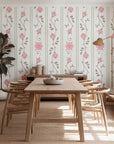Vintage floral stripe wallpaper with soft pink roses and taupe vines arranged in elegant vertical columns on a warm white background.